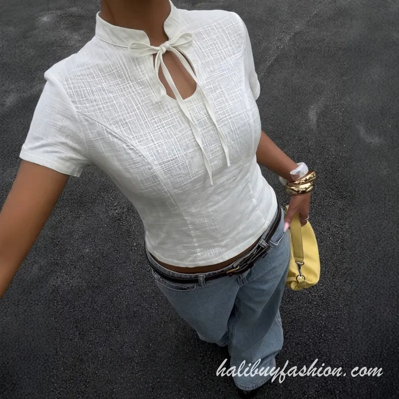Cut out short sleeve self tie textured top